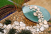 SMALL POOL FEATURE WITH PEBBLES