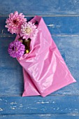 PINK AND PURPLE DAHLIAS IN PINK BAG