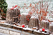 LARGE WICKER BELLS DECORATED WITH PINE CONES  ROSE HIP BRANCHES OF ROSA MULTIFLORA AND RED CHRISTMAS BALLS