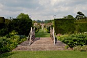 VIEW ACROSS BRIDGE TO THE FORMAL ROSE GARDEN AT OZLEWORTH PARK, GLOUCESTERSHIRE