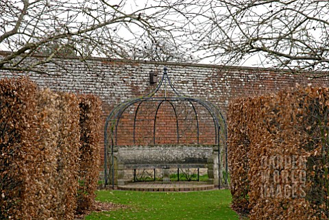 METAL_ARBOUR_AND_STONE_SEAT_AT_OZLEWORTH_PARK_GLOUCESTERSHIRE