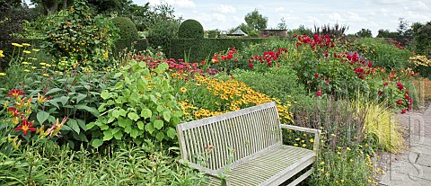 Garden_Room_called_the_Lanhydrock_Garden_with_wooden_garden_bench_borders_of_herbaceous_perennials_i