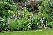 PERENNIAL BORDER WITH ROSES AND PAEONIES