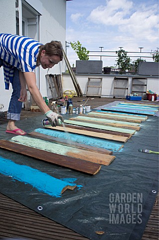 TIKI_HUT_BAR_BUILDING_PROJECT_ON_ROOF__LADY_SPRAYING_PAINT_ON_FRONT_PANELS__STEP_9