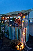 TIKI HUT BAR BUILDING PROJECT ON ROOF.  LADIES BEHIND THE COUNTER OF THE FINISHED PROJECT.  STEP 27