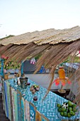 TIKI HUT BAR BUILDING PROJECT ON ROOF.  FINISHED WITH REED ROOF.  STEP 20