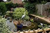 LARGE POND WITH ISLAND, DECOY HERON AND DUCK