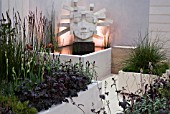 NS & I GARDEN,  DES. FREYA LAWSON. ROOF GARDEN WITH LIGHTWEIGHT PLANTERS AND SCULPTURE THE ARCHITECT BY JILLY SUTTON. INC. HEUCHERA CHOCOLATE RUFFLES,  H. PURPLE PETTICOATS,  LYSIMACHIA ATROPURPUREA BEAUJOLAIS