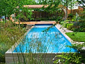 INFINITY EDGED SWIMMING POOL WITH SHADED SEATING PAVILION AT END. INC. STIPA GIGANTEA. CANCER RESEARCH UK GARDEN,  DES. ANDY STURGEON