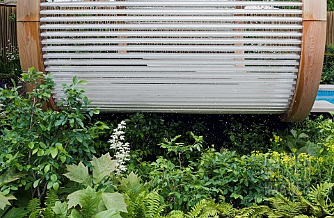 WATERFALL_ON_OUTSIDE_OF_PAVILION_RODGERSIA__FERNS_CANCER_RESEARCH_UK_GARDEN__DES_ANDY_STURGEON