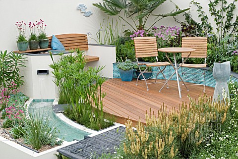 WATERFALL_AND_RILL_IN_COURTYARD__WITH_BENCH__GRAVEL__DECKING_MITIE_GARDEN__DES_JO_PENN