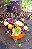 A PUMPKIN FILLED WITH FLOWERS