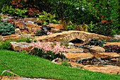 STONE BRIDGE AND  WATERFALL IN SMALL GARDEN