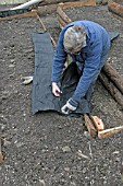 RAISED BEDS CUTTING WEED CONTROL MEMBRANE FOR PATHS