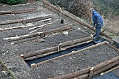 RAISED BEDS RAKING OUT THE STONE FOR THE PATHS