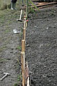 RAISED BEDS,  USE A LINE TO LINE UP THE END BOARD SUPPORT POSTS