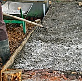 APPLYING WOOD ASH   RAKE INTO SOIL AFTER APPLICATION