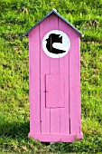 Little pink shed in a garden