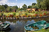 Riverside flower bed with: Verbena bonariensis, verbena sp, Canna, Tagetes erecta, Rudbeckia