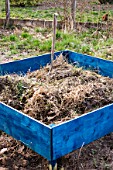 Digging in old herbaceous plants in a squarefoot garden