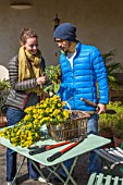 Young couple with flowers in a garden