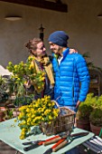 Young couple with flowers in a garden