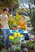 Young couple with flowers in a garden terrace