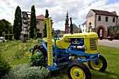Tractor as garden decoration, Garden Festival , Porte de Strasbourg and St Catherine Church in Bitche , Lorraine, France