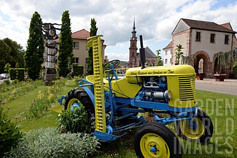 Tractor_as_garden_decoration_Garden_Festival__Porte_de_Strasbourg_and_St_Catherine_Church_in_Bitche_