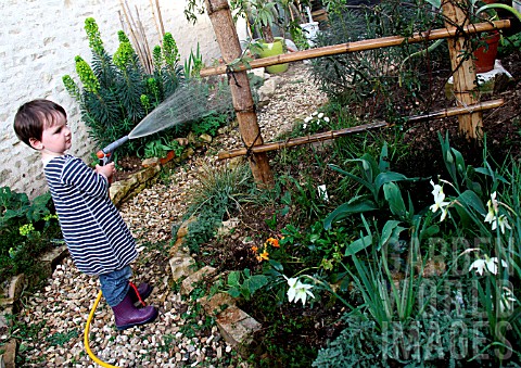 Child_watering_a_garden