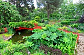 Small red wooden bridge in the botanical garden of Bayonne, Aquitaine, France