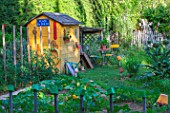 Garden shed with seating aera in a kitchen garden in June, Provence, France