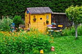 Garden shed with Cosmos seating area in July, Provence, France