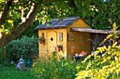 Garden shed with squash and seating area in July, Provence, France