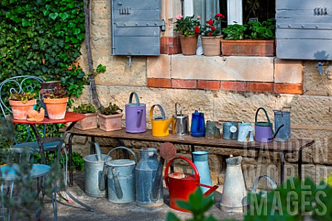 Collection_of_watering_cans_on_a_bench_Provence_France