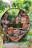 Rocambole gardens, Artistic vegetable and botanical gardens in organic farming, A meeting between art and Nature, Insect hotel against a wall , insect shelter made of different materials, La Lande aux Pitois, Corps Nuds, Ille-et-Vilaine (35), Brittany, France
