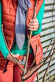 Woman pruning a fig tree in winter. Suppression of the central axis to obtain a more spread out subject.