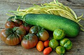 Harvest from the vegetable garden: courgette (Cucurbita pepo), butter beans (Phaseolus vulgaris), tomatoes (Solanum lycopersicum)