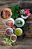 Garden treasures, edible and officinal plants: rose petals (Rosa sp), poppy (Papaver rhoeas), lime (Tilia sp), camomile (Matricaria recutita), mint (Menta sp), thyme (Thymus vulgaris), rosemary (Rosmarinus officinalis), saffron (Crocus sativus) in infusion and herbal tea