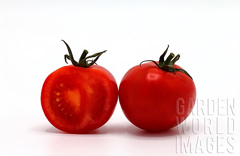 Half_ripe_tomato_and_a_whole_red_tomato_on_a_light_background_Natural_product_Natural_color_Closeup
