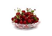 Ripe cherry in a translucent beautiful plate on a light background. Natural product. Natural color. Close-up.