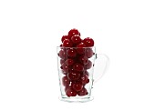 Ripe cherry in a transparent glass on a light background. Natural product. Natural color. Close-up