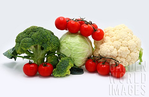 Head_of_cabbage_inflorescences_of_broccoli_and_cauliflower_and_red_ripe_tomatoes_on_a_light_backgrou