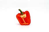 One red ripe sweet pepper in a cut on a light background. Natura