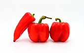 Three red ripe sweet peppers on a light background. Natural product