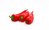 Three red ripe sweet peppers on a light background. Natural product