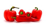 Several red ripe sweet peppers of different shapes on a light background. Natural product. Natural color. Close-up.
