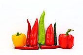 Composition of several types of sweet pepper of different shapes, colors and sizes on a light background. Natural product. Natural color. Close-up.