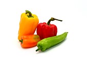 Composition of several types of sweet pepper of different shapes, colors and sizes on a light background. Natural product. Natural color. Close-up.