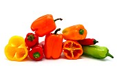 Composition of several sweet peppers and their halves of different colors on a light background. Natural product. Natural color. Close-up.